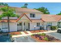 Two-story townhome featuring a red tile roof and front yard landscaping at 3522 Forest Branch Dr # D, Port Orange, FL 32129