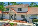 Charming two-story townhome with well-maintained landscaping and a classic red tile roof at 3522 Forest Branch Dr # D, Port Orange, FL 32129