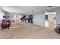 Bright living room with neutral carpeting, featuring a grand piano and access to other areas at 950 Pineapple Rd, South Daytona, FL 32119
