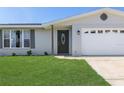 Close up of front door and garage of charming home at 105 Bonita Pl, Ormond Beach, FL 32174