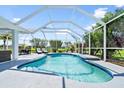 A lovely screened-in pool area featuring lounge chairs and outdoor dining at 1904 Rouzbeh Ct, Port Orange, FL 32128