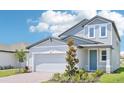 Beautiful two-story home with a large two-car garage, stone accents, and manicured landscaping at 288 Links Terrace Blvd, Daytona Beach, FL 32124
