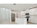 Modern kitchen features white cabinets, stainless steel appliances, and a center island at 288 Links Terrace Blvd, Daytona Beach, FL 32124