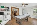 Relaxing game room includes a pool table and views into the kitchen through an open doorway, plus entertainment options at 920 N Lakewood Ter, Port Orange, FL 32127