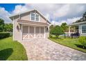 Detached garage with stylish doors and well-maintained landscaping at 96 Grove St, Ormond Beach, FL 32174