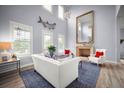 Elegant living room with high ceilings, large windows, and a cozy fireplace at 96 Grove St, Ormond Beach, FL 32174