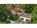 Aerial view of the property showing house, detached garage, and landscaping at 16639 Morningside Dr, Montverde, FL 34756