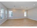 Bright open-concept living room features recessed lighting, smooth walls, and stunning light wood floors at 9762 Neruda St, Orlando, FL 32827