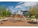 Community playground with modern play structure in a residential neighborhood with newly built homes on a sunny day at 13664 Mcmillan Dr # 146C, Orlando, FL 32827