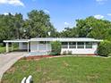 Front view of a ranch home with mature trees at 2734 Vindale Rd, Tavares, FL 32778