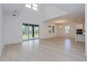 A spacious living room features high ceilings and large sliding glass doors leading to the backyard at 6370 Trailblaze Bnd, St Cloud, FL 34771