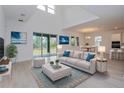 Bright, airy living room with high ceilings, large windows, and sliding glass doors to outdoor living space at 6370 Trailblaze Bnd, St Cloud, FL 34771
