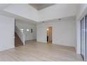 Spacious living room area with high ceilings, plenty of natural light, and access to stairs and hallway at 6370 Trailblaze Bnd, St Cloud, FL 34771