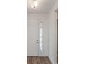 Front entry with white door and wood-look tile floor at 13200 Peaceful Melody Dr, Winter Garden, FL 34787
