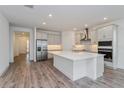 Modern kitchen with island, stainless steel appliances, and white cabinets at 13200 Peaceful Melody Dr, Winter Garden, FL 34787