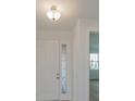 Bright entry hall with white door and small window at 13230 Peaceful Melody Dr, Winter Garden, FL 34787