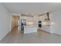 Modern kitchen with white cabinets, stainless steel appliances, and island at 13230 Peaceful Melody Dr, Winter Garden, FL 34787