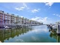 Canal view of condo building and marina with boats at 4624 Harbour Village Bv # 4205, Ponce Inlet, FL 32127