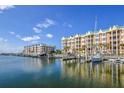 Waterfront view of modern condo building and boats at 4624 Harbour Village Bv # 4205, Ponce Inlet, FL 32127