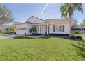 One-story house with a large backyard, and a palm tree at 2441 Prairie Dunes, Clermont, FL 34711