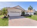 Brick paver driveway and two-car garage at 2441 Prairie Dunes, Clermont, FL 34711