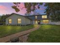Charming two-story home with brick pathway, manicured lawn, and fresh white paint at 1635 Hilltop Dr, Mount Dora, FL 32757
