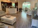 Open concept living area with kitchen and dining views at 5596 Cedar Waxwing Dr, The Villages, FL 32163