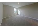 Bright and airy bedroom with plush carpeting and large window at 715 Griffon Ave, Lake Alfred, FL 33850