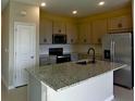 Modern kitchen featuring granite countertops and stainless steel appliances at 715 Griffon Ave, Lake Alfred, FL 33850