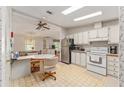 Inviting kitchen features white cabinets and stainless steel appliances at 1653 Kiley Ct, The Villages, FL 32159