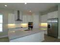 Modern kitchen featuring white cabinetry, stainless steel appliances, and a spacious center island at 10218 Dulbecco St, Orlando, FL 32827