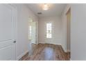 Bright entryway with wood-look tile floor and neutral colors at 10260 Medawar St, Orlando, FL 32827