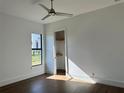 Bright bedroom with wood floors and a walk-in closet at 16122 Pendio Dr, Bella Collina, FL 34756