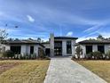 Luxury home showcasing modern design and landscaping at 16122 Pendio Dr, Bella Collina, FL 34756