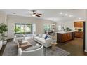 Open-concept living space with kitchen island and sliding glass doors to backyard at 3682 Arlington Ridge Blvd, Leesburg, FL 34748