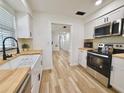 Bright kitchen features butcher block counters, stainless appliances, and a view into the living areas at 14598 Sw 34Th Terrace Rd, Ocala, FL 34473