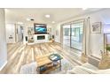 Spacious living room with built-in shelving, fireplace, and sliding glass doors to an enclosed patio at 14598 Sw 34Th Terrace Rd, Ocala, FL 34473