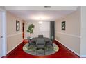 Cozy dining room showcases a round table with seating for four and a stylish rug at 601 W Old Hwy 441 # 11B, Mount Dora, FL 32757