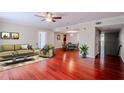 Bright living room features a ceiling fan, stylish furniture, and beautiful hardwood floors at 601 W Old Hwy 441 # 11B, Mount Dora, FL 32757