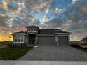 Beautiful single-Gathering home with a three-car garage and brick-paved driveway and stone design accents at 2311 Juniper Berry Dr, Minneola, FL 34715