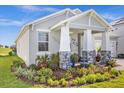 Exterior view of a charming house with a well-manicured front yard and fountain at 30057 Island Club Dr, Tavares, FL 32778