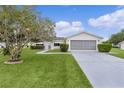 Charming single-story home featuring a well-maintained lawn and an attached two-car garage with screened doors at 17574 Se 106Th Ave, Summerfield, FL 34491