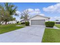 Charming single-story home featuring a well-maintained lawn and an attached two-car garage with screened doors at 17574 Se 106Th Ave, Summerfield, FL 34491