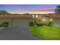 Two-story home with manicured lawn, two-car garage, and a welcoming front entrance at dusk at 1111 Lakeshore Dr # A3, Eustis, FL 32726