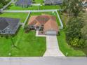 Aerial view of a single Gathering home featuring a large, fenced backyard with lush green grass at 8830 Se 161St Pl, Summerfield, FL 34491