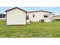 Spacious backyard with shed and grassy area at 1209 Apache Cir, Tavares, FL 32778