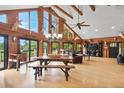 Spacious living room featuring hardwood floors, vaulted wood ceilings, and an abundance of natural light at 26348 Se Highway 42, Umatilla, FL 32784