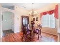 Elegant dining room with wood floors, classic chandelier, and a china cabinet at 3506 Mulberry Grove Loop, Leesburg, FL 34748