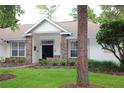 Brick front home with a welcoming porch and mature trees at 2360 Park Forest Blvd, Mount Dora, FL 32757