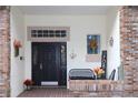 Inviting front porch with black door and seasonal decor at 2360 Park Forest Blvd, Mount Dora, FL 32757